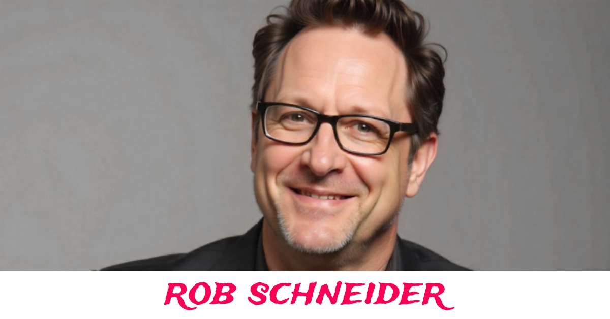 Rob Schneider posing at a Hollywood event in a classic black suit